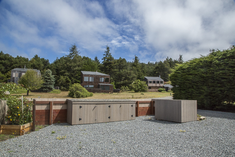 The parking area in front of the home with a view of other homes across the street.