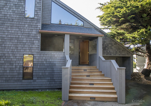 Exterior of a home showing the stairway and front door.