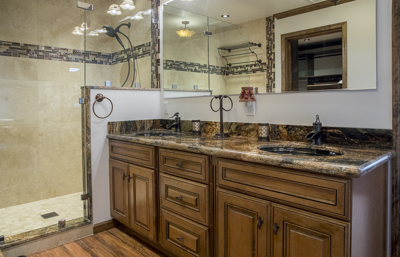 The bathroom showing the counter, sink and shower.