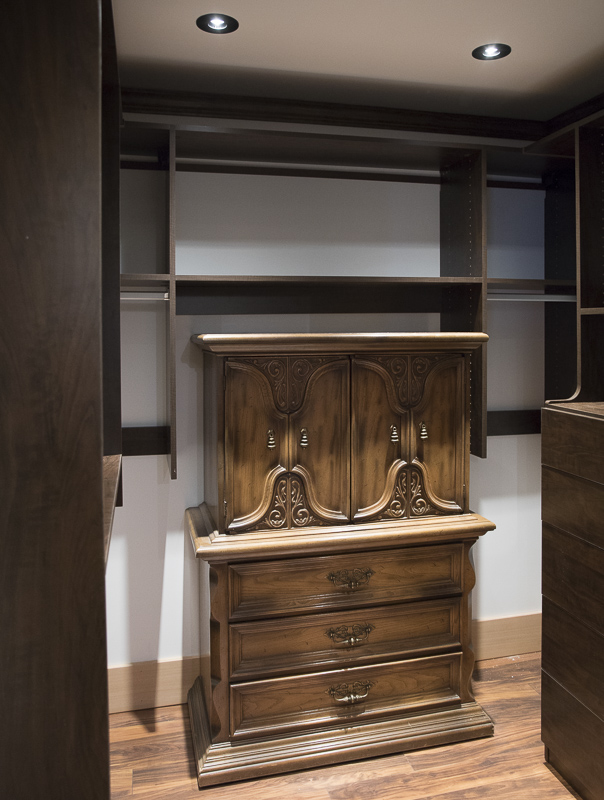 A dresser cabinet inside a closet.