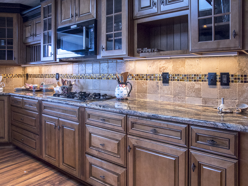 The kitchen counter showing the builtin stovetop and cupboards and drawers.