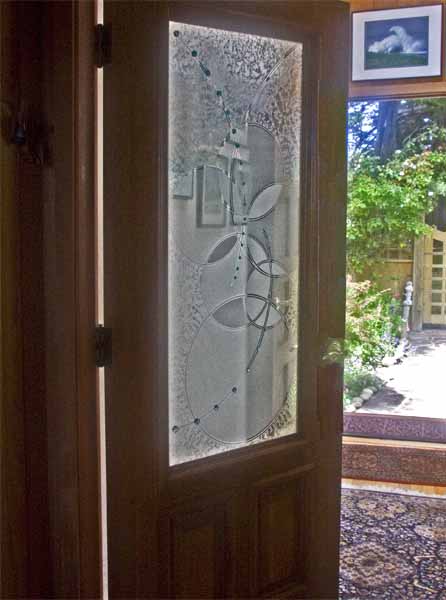 Front door slightly ajar looking out into the garden.