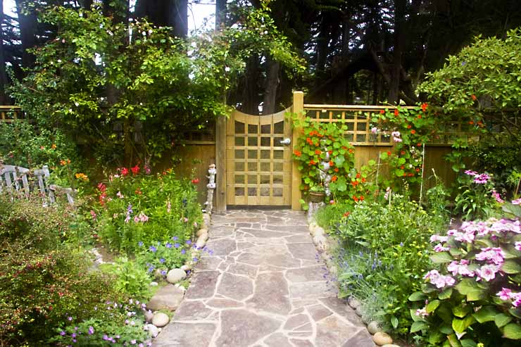 Interior of a fence with walkway and garden.