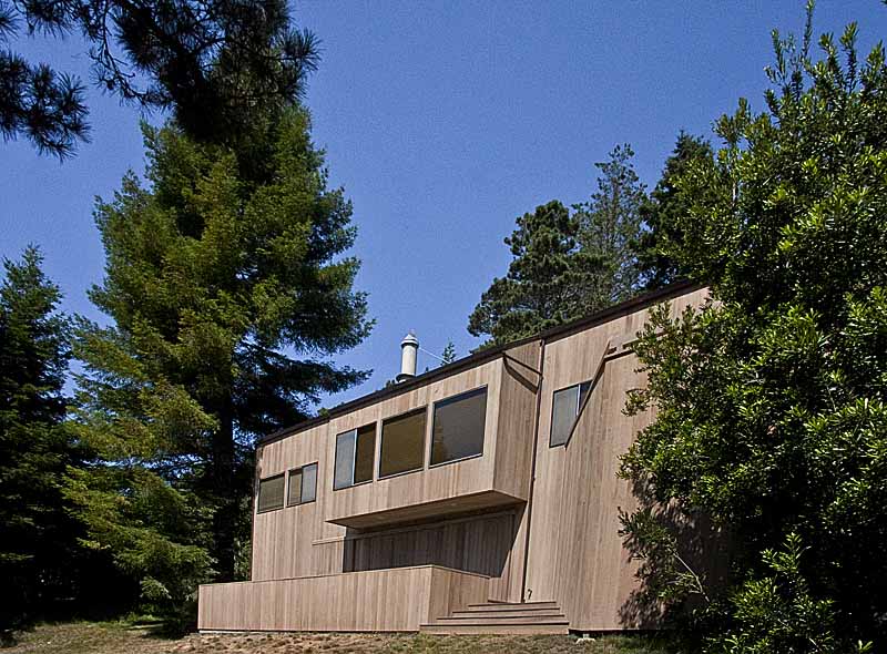 The back of the home showing the finished siding and deck.